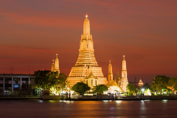 Naklejka premium View of the Wat Arun temple on the night illumination at sunset. Bangkok, Thailand