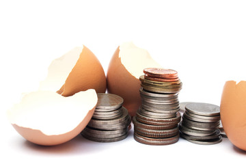 Half egg shell and coin, isolated on white background