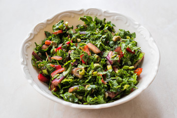 Chopped Parsley Salad with Tomatoes and Onions in Ceramic Bowl on Marble Surface.
