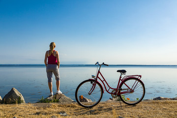Healthy lifestyle - middle-aged woman with bike at seaside
