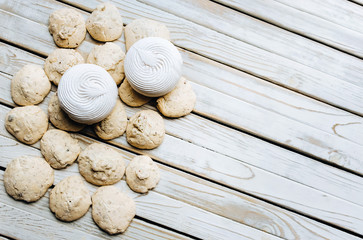 Top view on Merengue, Marshmallow, Zephyr on wooden background. Flat lay. Pastry concept, copy space. Rustic. Zephyr.