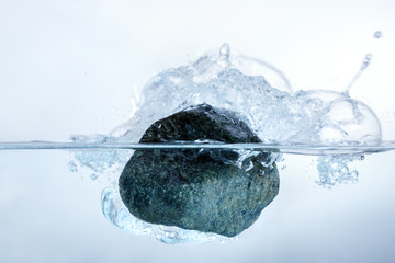Concept solution to the problem, puzzle, difficulty. Man throws a stone of problems in the water.
