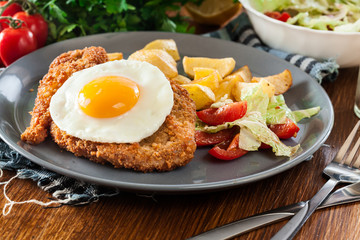 Breaded viennese schnitzel with fried agg