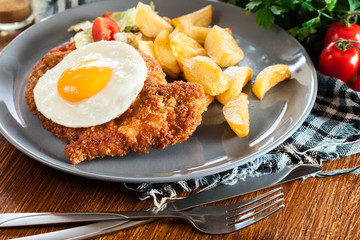 Breaded viennese schnitzel with fried agg