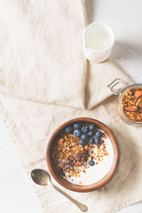 Homemade granola muesli with blueberries on white background breakfast
