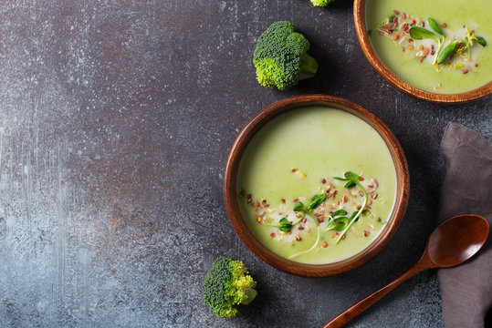 Green vegetable broccoli soup on dark grey background