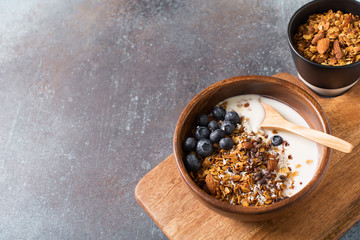 Homemade granola muesli with blueberries ondark grey background breakfast