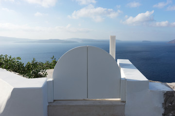 White door overlooking the Mediterranean sea, Oia, Santorini. Greece