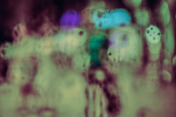 Abstract circular bokeh background of night light with raindrops