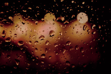 Abstract circular bokeh background of night light with raindrops