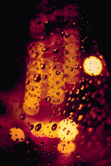 Abstract circular bokeh background of night light with raindrops
