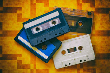 Several music cassette tapes on an orange background