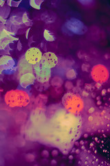Abstract circular bokeh background of night light with raindrops
