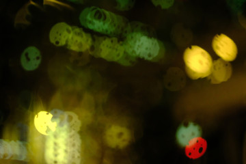 Abstract circular bokeh background of night light with raindrops