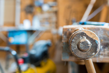 Wood workbench in carpentry workshop, focus on the wise, shallow depth of field.