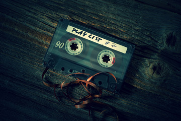 Old classic audio cassette with pulled out of tape
