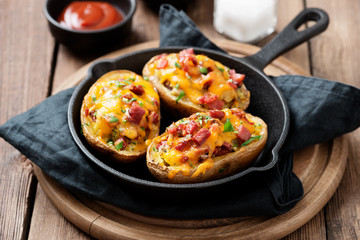 Hot baked potato topped with bacon, green onions and cheddar cheese.