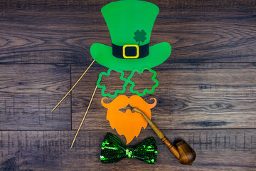 Saint Patrick Day concept. Paper Patrick day leprechaun props: green leprechaun hat, orange...