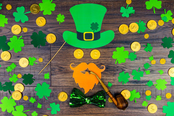 Saint Patrick Day concept. Paper Patrick day leprechaun props: green leprechaun hat orange beard...