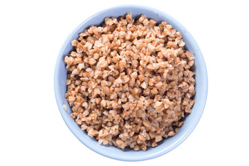Boiled buckwheat in blue plate top view on white isolated background