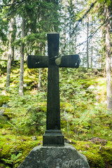 Cross at old beautiful semetery in Finland.