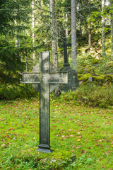 Cross at old beautiful semetery in Finland.