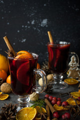 milled Hot wine with Christmas decorations background. Holiday dark photo.