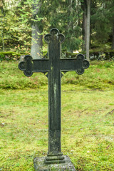 Cross at old beautiful semetery in Finland.