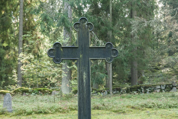 Cross at old beautiful semetery in Finland.