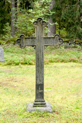 Cross at old beautiful semetery in Finland.