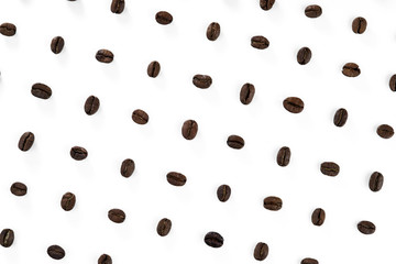 A pattern of roasted coffee beans placed in rows on a white background.