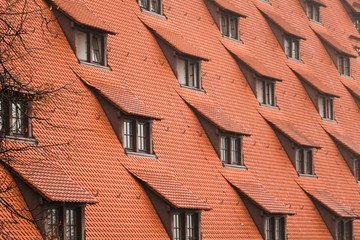 Collection of roof windows on a large building with red roof near the Kaiserburg in Nürnberg / Nuremberg (Nuremberg, Germany, Europe)