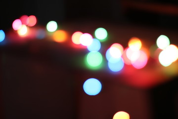 Bokeh light that has many spherical shapes and many colors on the background with blur and darkness.