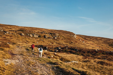 A couple hiking in the mountain at sunrise