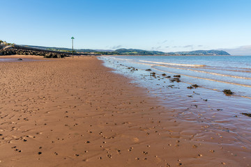 The beach in Blue Anchor, Somerset, England, UK - looking at the Bristol channel and Minehead in the background