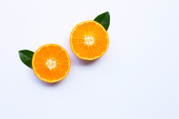 Fresh orange citrus fruits with leaves on white background.