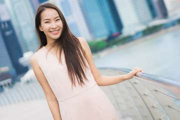 Beautiful asian woman smile and happy to travel in singapore city