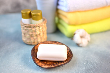 Soap on a wooden plate on a bathroom counter table