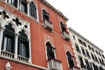 Obraz premium Venice / Italy - February 02 2018. Venetian architecture. Street with red house.