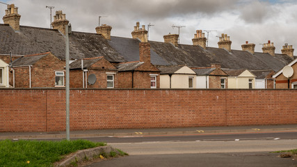 Houses behind a wall in a street in Taunton, Somerset, England, UK