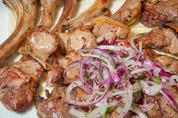 Mutton kebab on plate, close up view . Kebab with onion . Sheep meat Kebab.