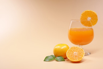 Oranges and Orange juice on orange color background with copy space.