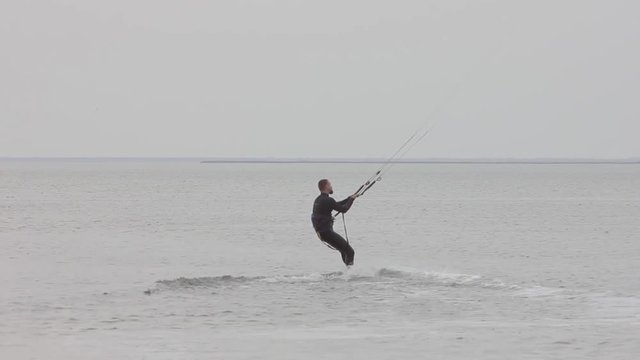 Aerial view of a young man ( wooman )  kitesurfing in on the islands