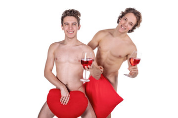 Two funny naked guys holding glasses with red wine and heart isolated on white background