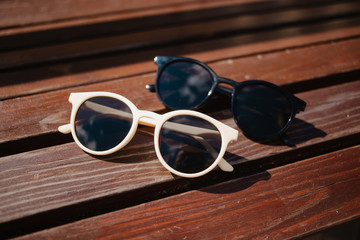 Fototapeta na wymiar stylish sunglasses and on a wooden background