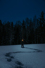 Creepy man on snowy field full moon