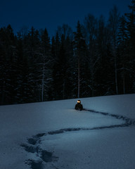 Creepy man on snowy field full moon