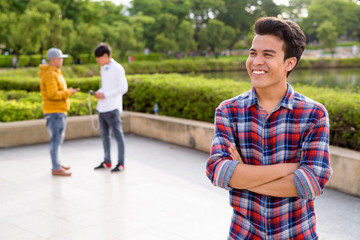 Obraz premium Three young Asian men relaxing at the park together