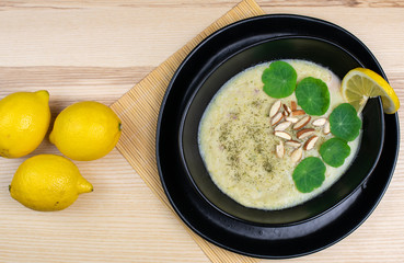 Zucchini cream soup in black bowl