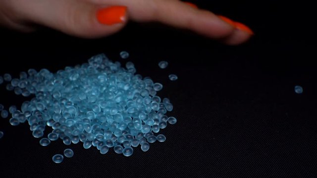 Women's hands hold a blue topaz or a precious stone and check the quality. 1920X1080 Full Hd.